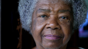A senior black woman portrait face close-up staring at camera an