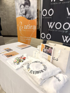 ATIRA representatives at the Women of Oakwyn event with ATIRA and WOO banners displayed