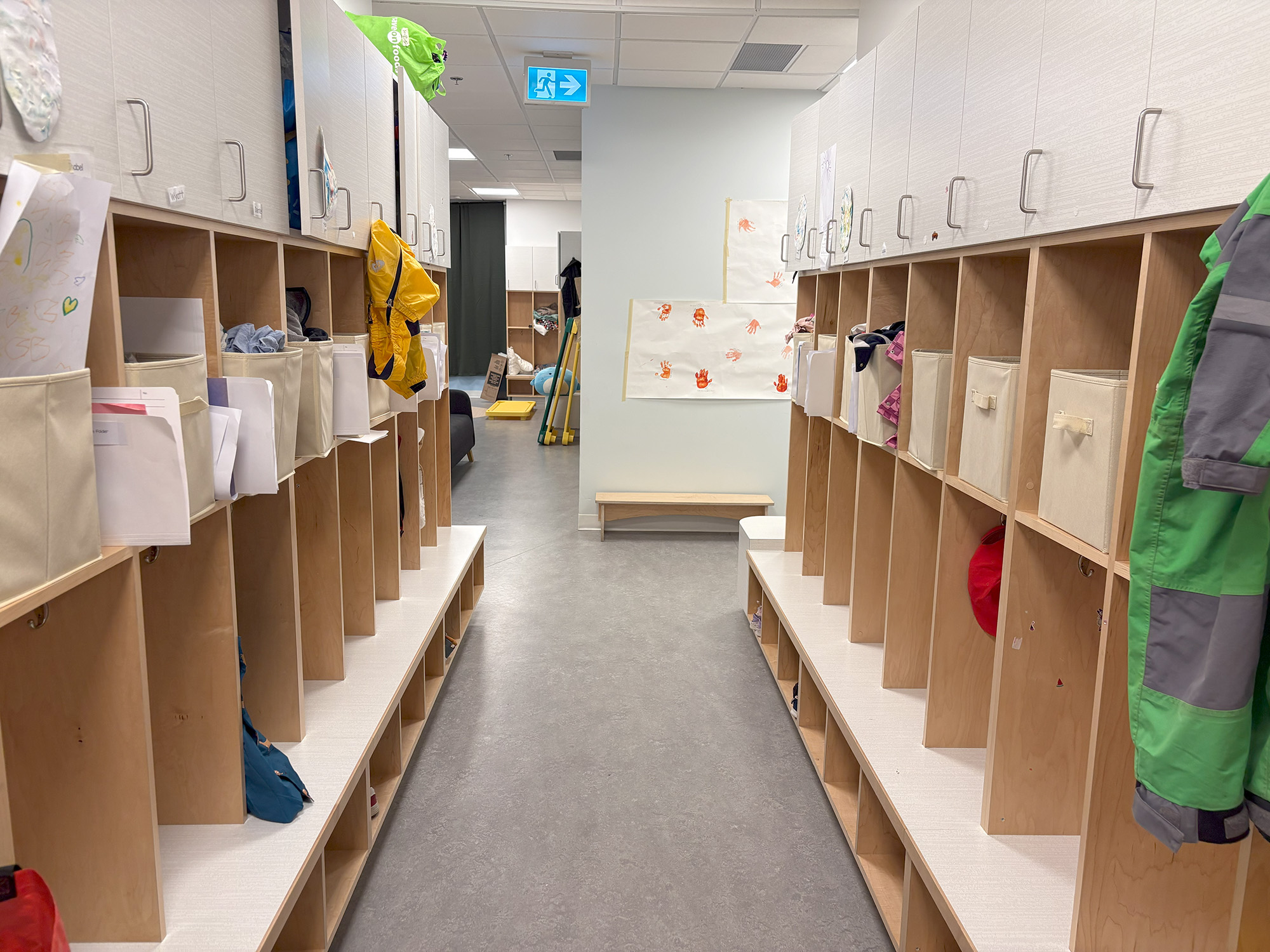 A storage room with wooden shelves used for keeping children’s belongings and personal items