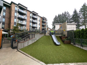A building with a children’s park area in front of it
