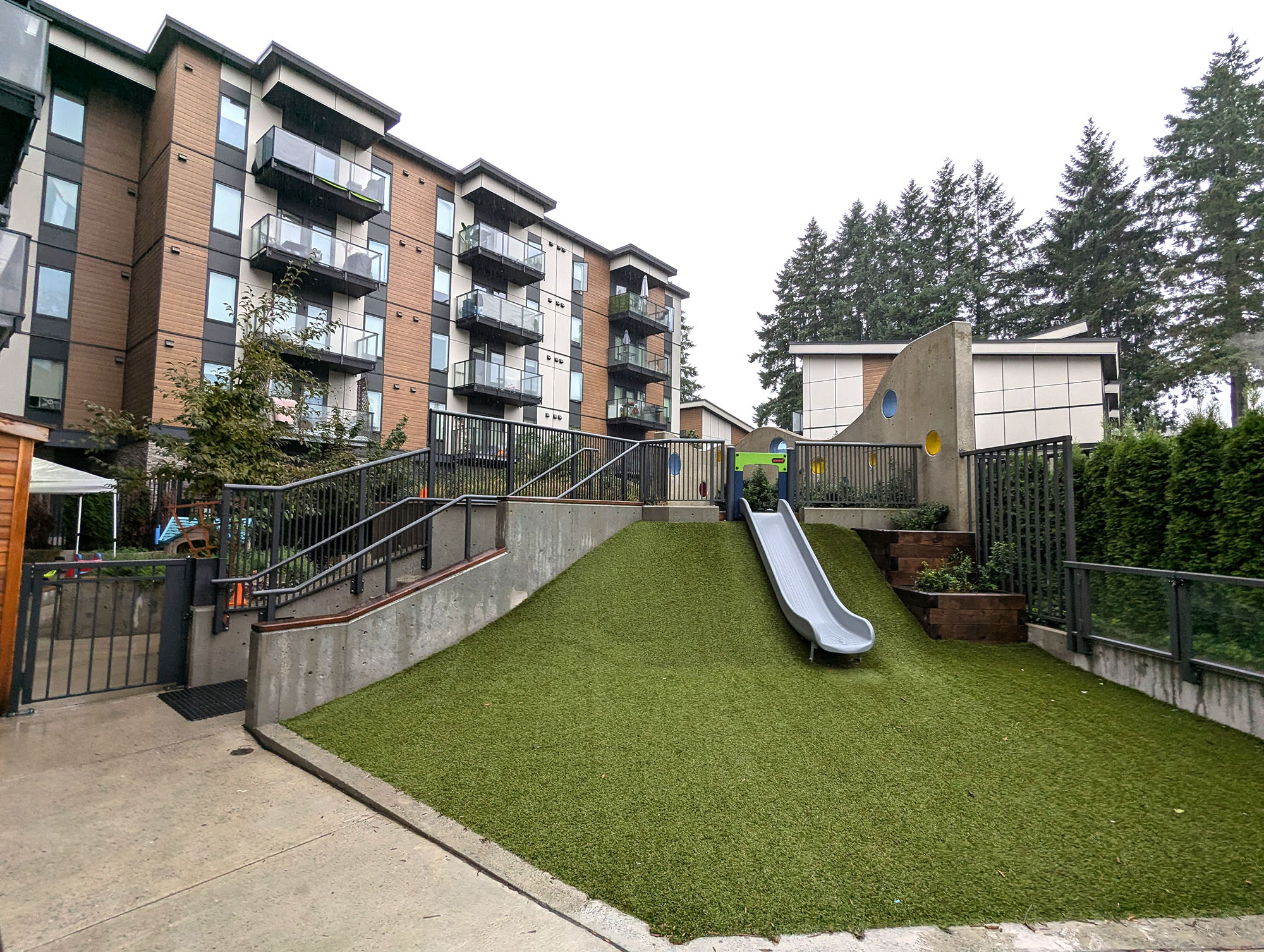 A building with a children’s park area in front of it